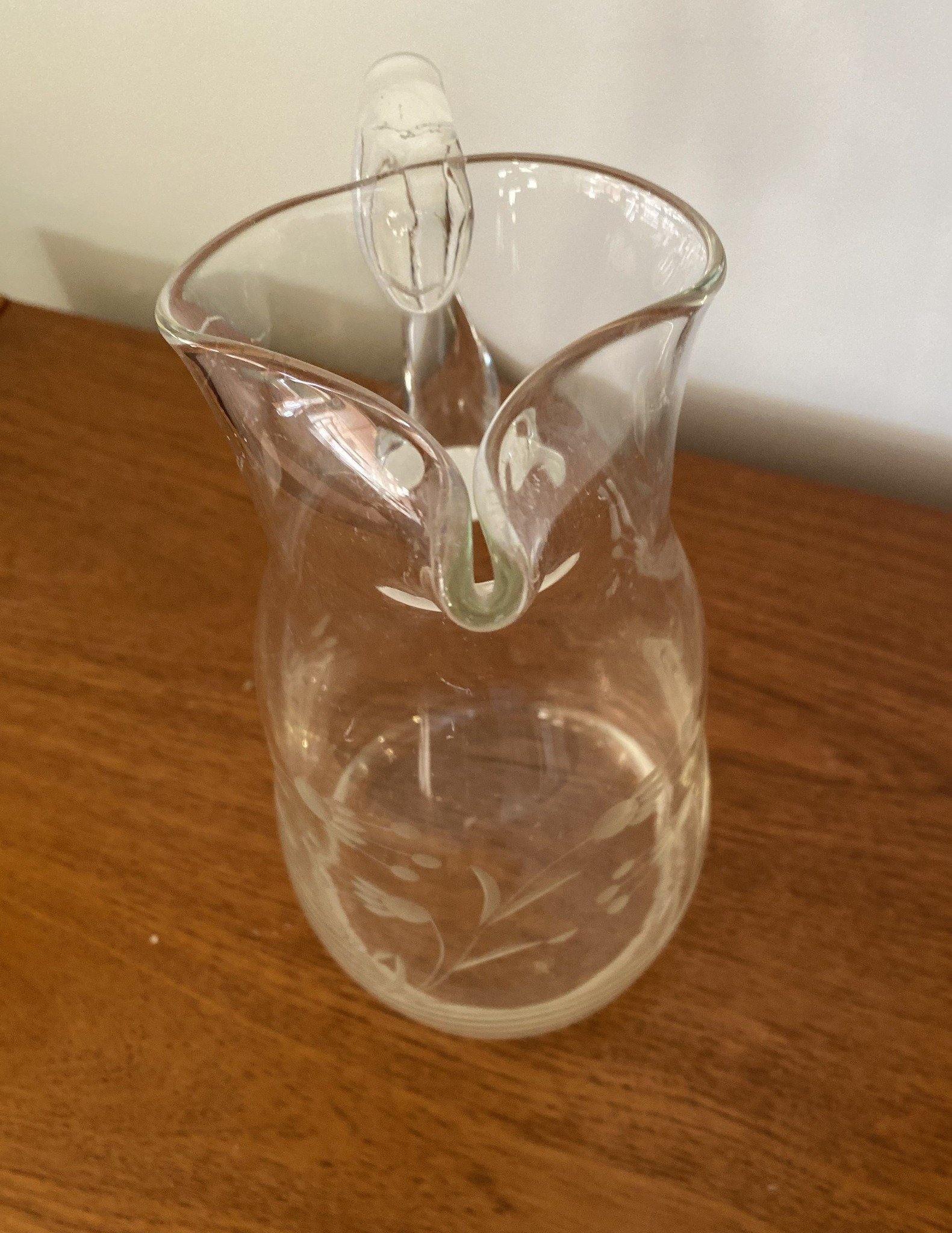 Front view of glass pitcher with stylized engraved flowers with pinched spout Cook Street Vintage