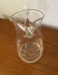 Front view of glass pitcher with stylized engraved flowers with pinched spout Cook Street Vintage