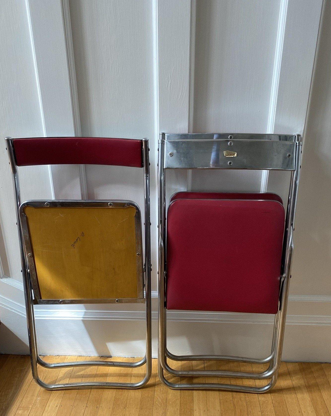 folded red vinyl and chrome folding chairs showing bottoms and seats-Cook Street Vintage