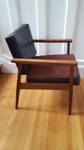 Side view of teak arm chair and black vinyl upholstery- Cook Street Vintage