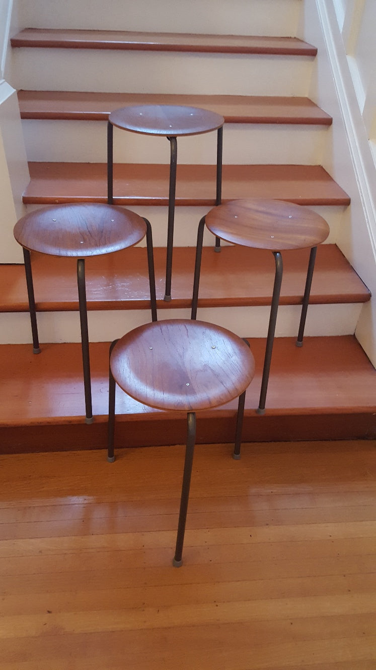 Set of 4 vintage teak plywood and steel dot stools on metal tripod legs. Originally designed by Arne Jacobsen- Cook Street Vintage