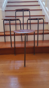 Set of 4 vintage teak plywood and steel dot stools on metal tripod legs. Originally designed by Arne Jacobsen- Cook Street Vintage