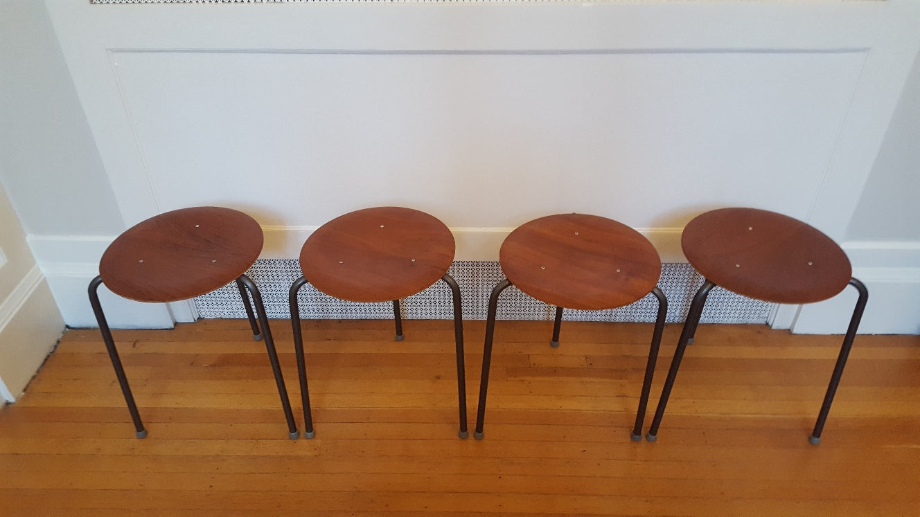 Set of 4 vintage teak plywood and steel dot stools on metal tripod legs. Originally designed by Arne Jacobsen- Cook Street Vintage