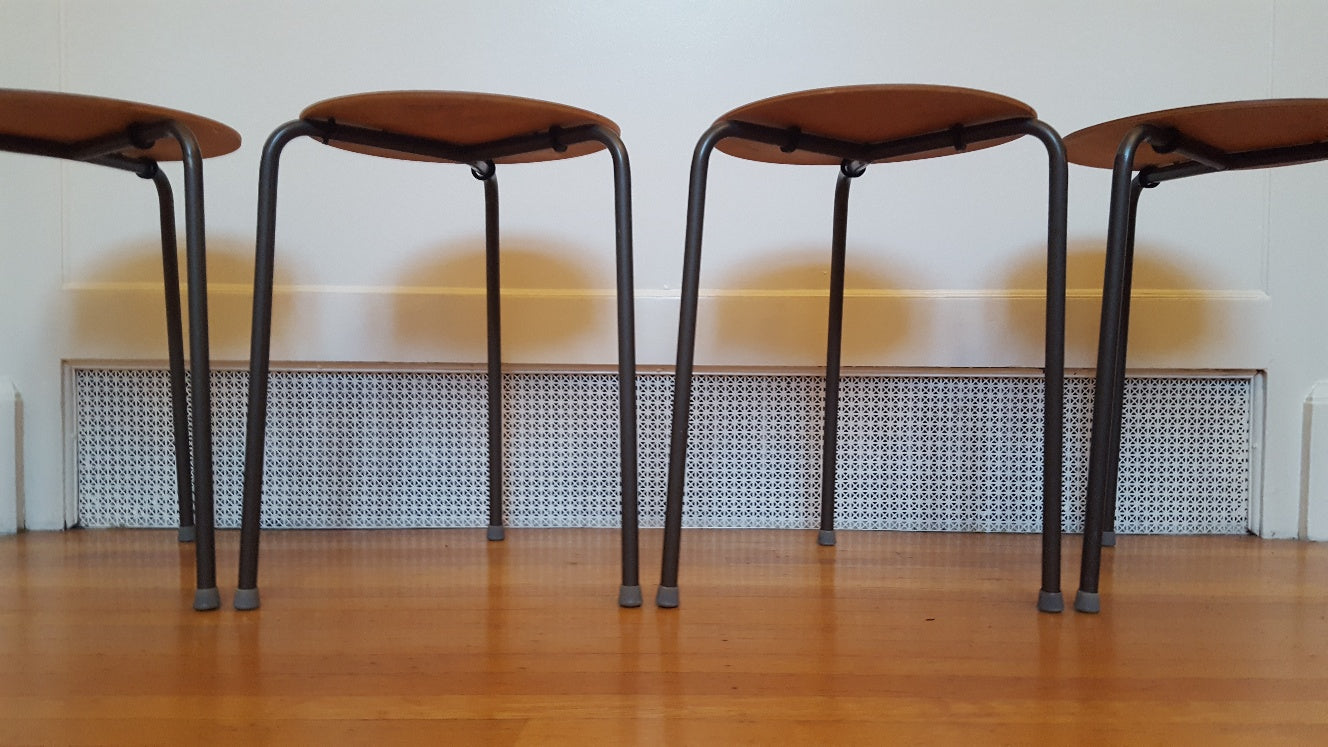 Set of 4 vintage teak plywood and steel dot stools on metal tripod legs. Originally designed by Arne Jacobsen- Cook Street Vintage