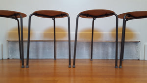 Set of 4 vintage teak plywood and steel dot stools on metal tripod legs. Originally designed by Arne Jacobsen- Cook Street Vintage