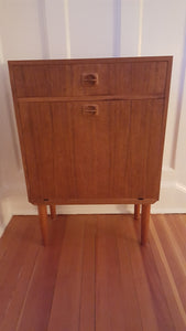 Retro Vintage Teak Cocktail Bar Cabinet features a mirror, glass shelf, and drawer space- Cook Street Vintage