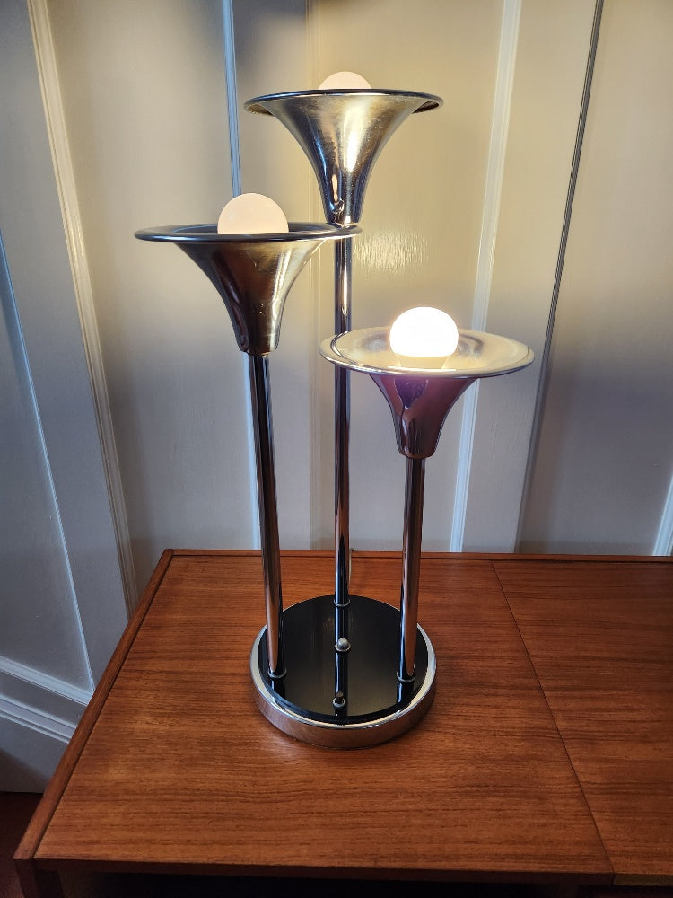 A classic three head chrome trumpet with 9 inch plastic and metal base. One or three light option. Design attributed to Geffrey Reggiani -Cook Street Vintage