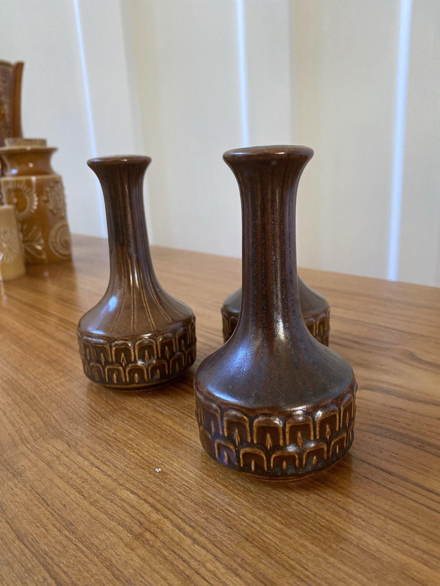 CLose up of one of three matching brown ceramic salt shakers- Cook Street Vintage-