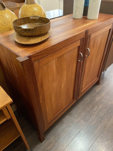 Side view of teak bar storage cabinet showing gentle tapered legs- Cook Street Vintage