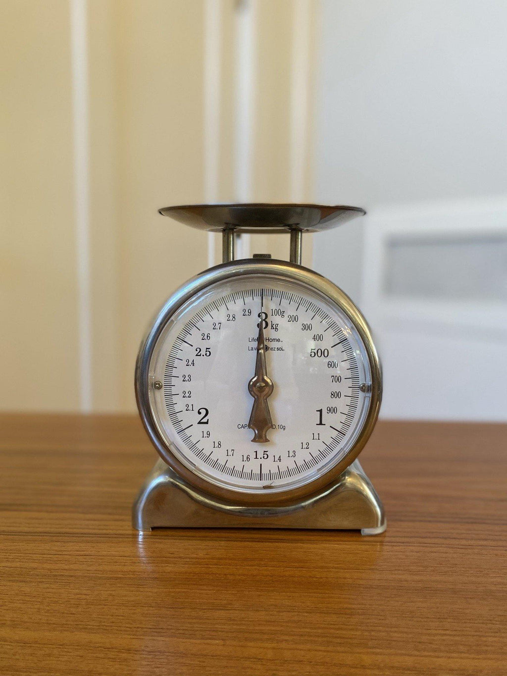 Front view of chrome kitchen scale on teak table- Cook Street Vintage