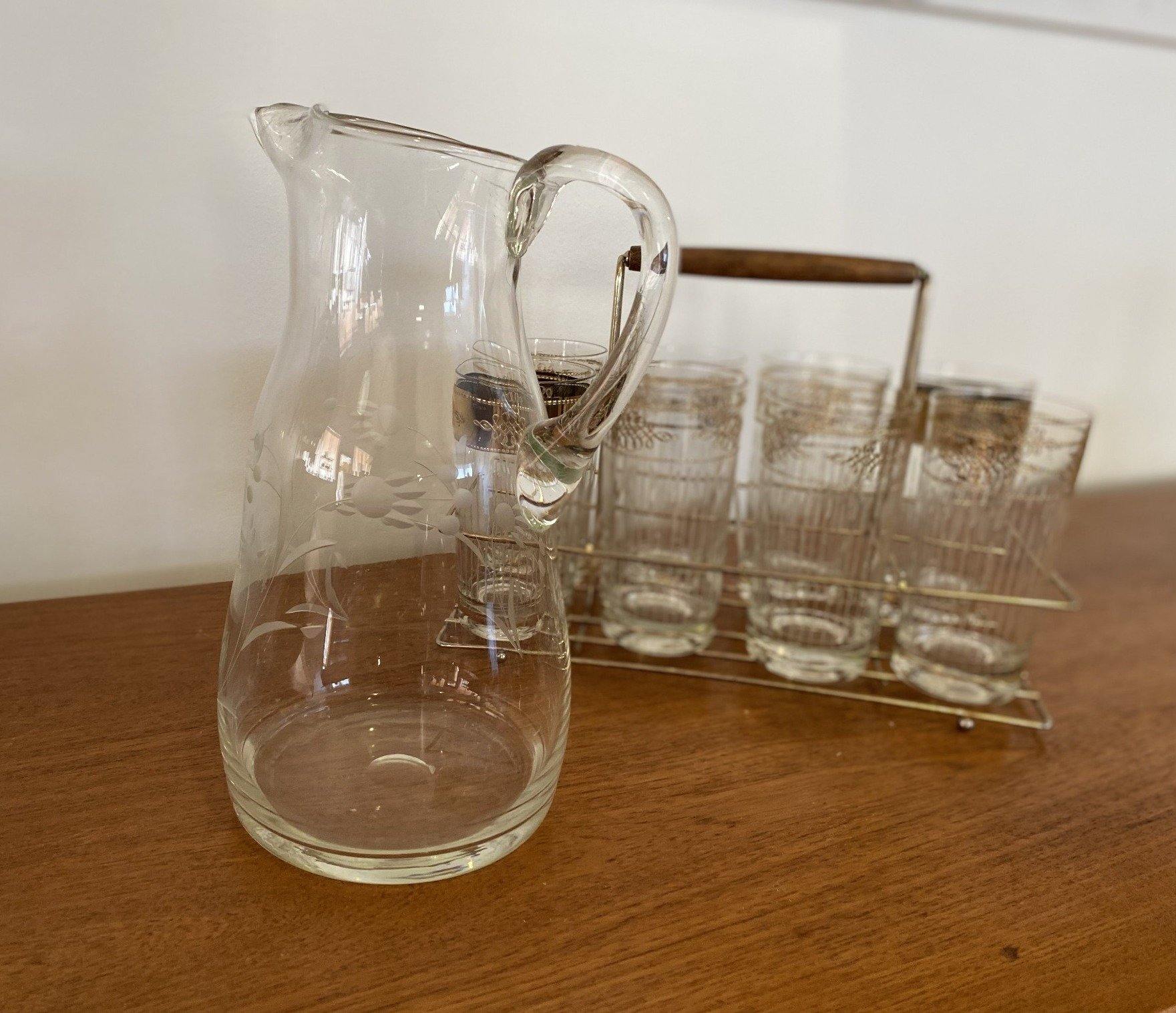 Vintage glass pitcher iwth stylized embossed flowers with 8 cocktail glasses in background- Cook Street Vintage