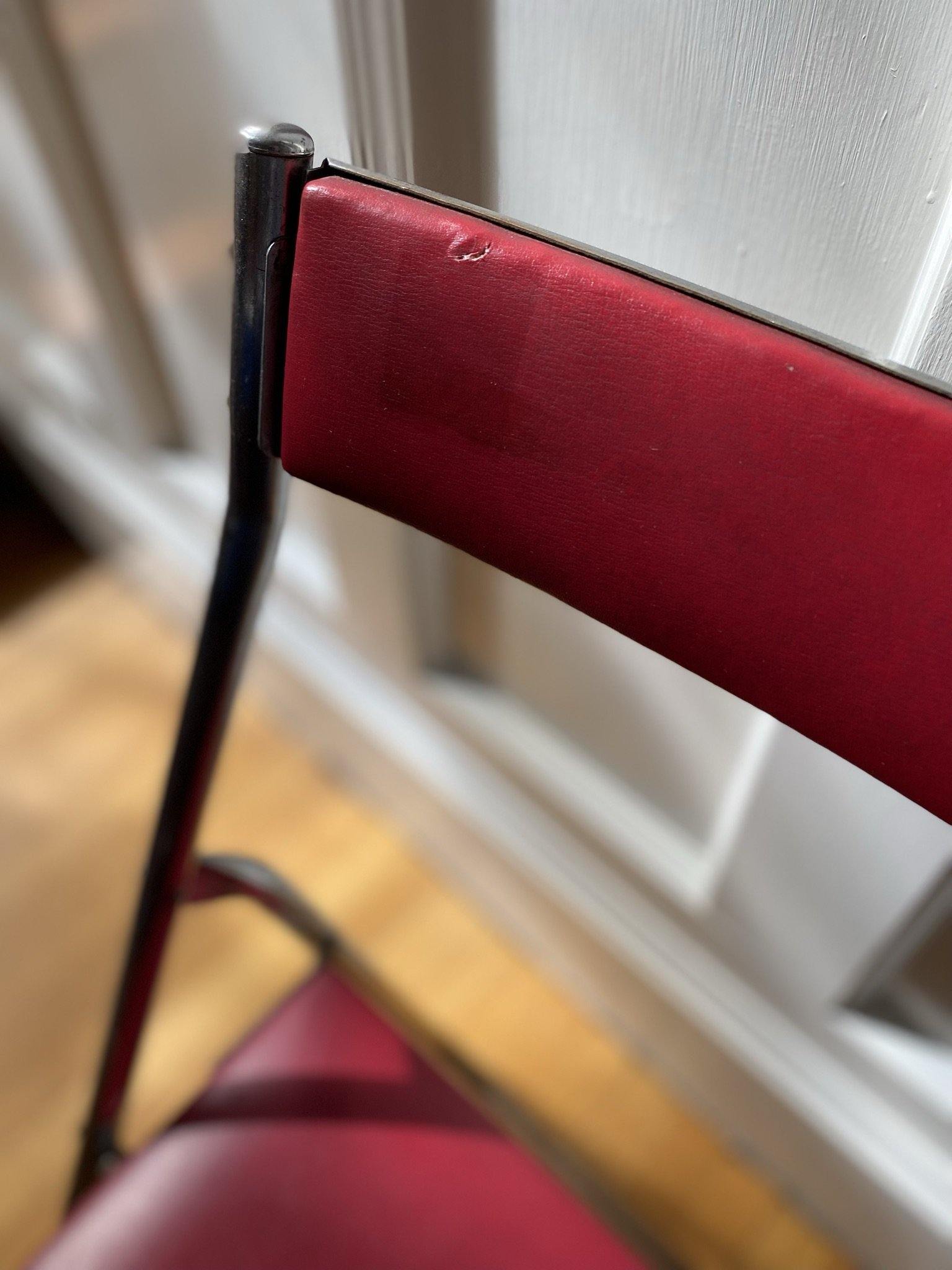 Close up of back of chrome and vinyl chair showing small tear- Cook Street Vintage