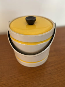 Back view of cream vinyl ice bucket with yellow details and white carrying handle and wood knob- Cook Street Vintage