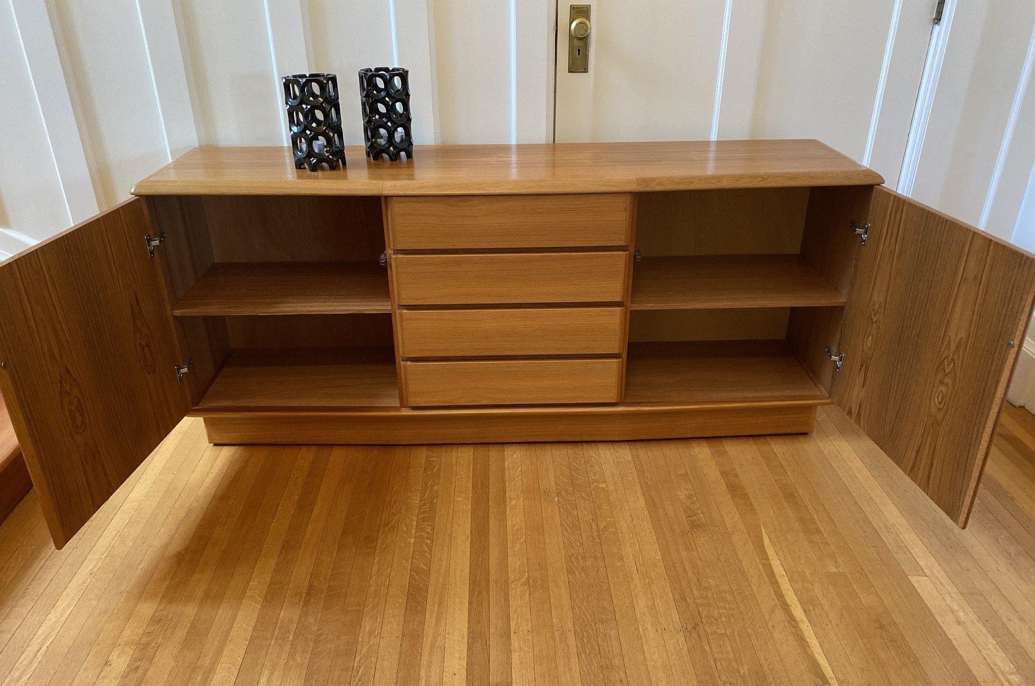 Front view of teak side board by Nordic Furniture with cabinet doors open showing shelves and four drawers closed- Cook Street Vintage