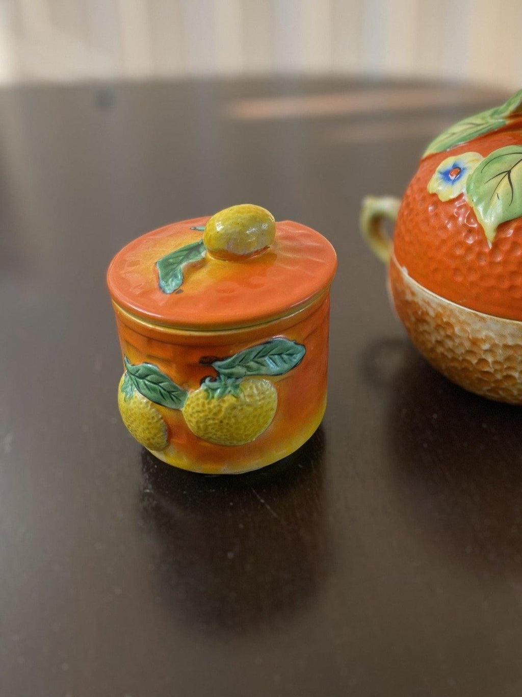 Side view of small orange jam and jely pot with matching tea pot with lemon motifs- Cook Street Vintage