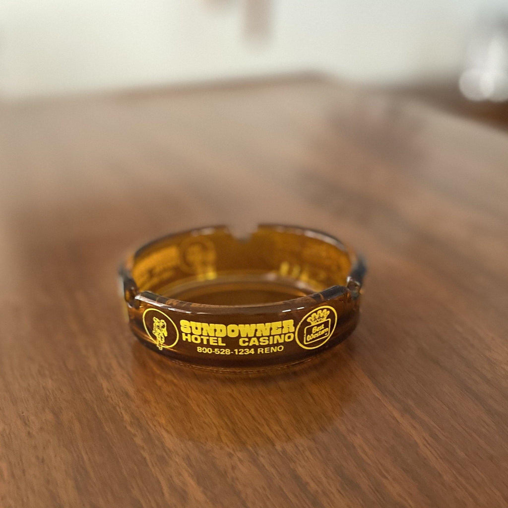 Amber ashtray from Sundowner Hotel and Casino on a teak table- Cook Street Vintage