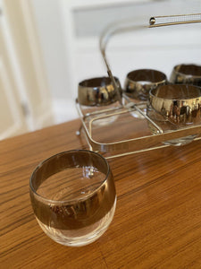 close up of a roly poly round bottom cocktail glass with other glasses in holder behind it- Cook Street Vintage
