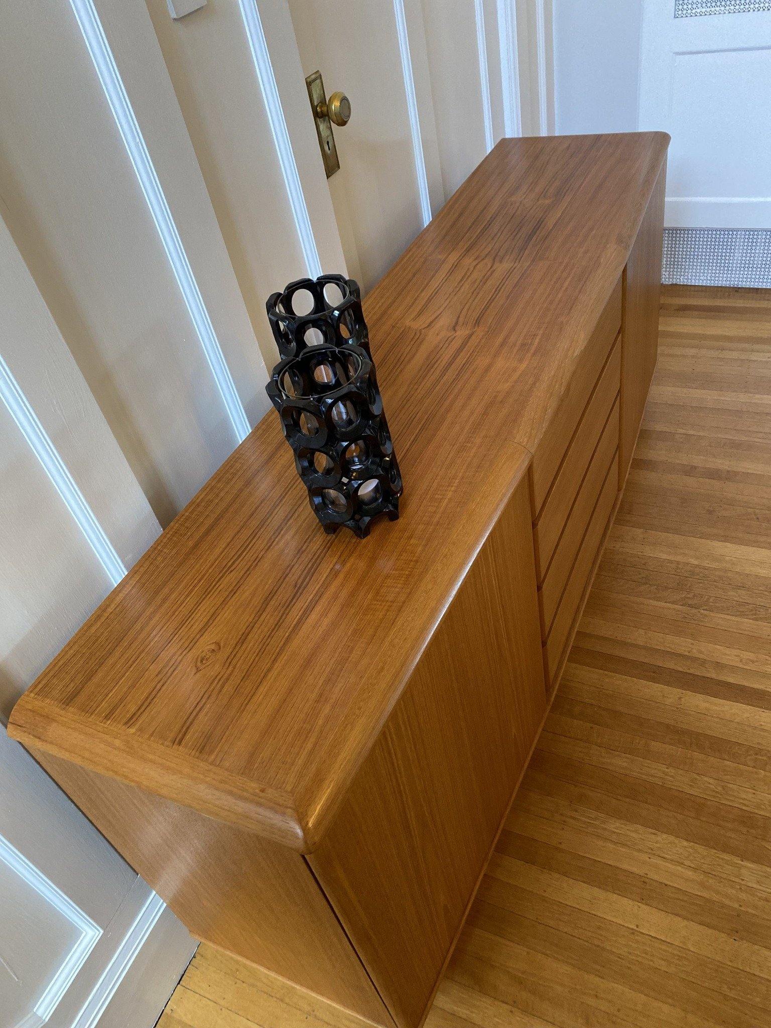 Birds eye view of top of teak Nordic Furniture credenza with two black lanterns_-Cook Street Vintage