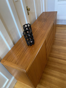 Birds eye view of top of teak Nordic Furniture credenza with two black lanterns_-Cook Street Vintage