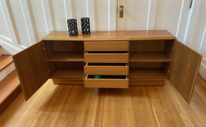 Front view of Teak Credenza by Nordic Furniture with cabinet doors and four drawers open- Cook Street Vintage