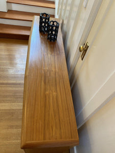 Birds eye view of top of teak Credenza by Nordic Furniture with two black lanterns- Cook Street Vintage