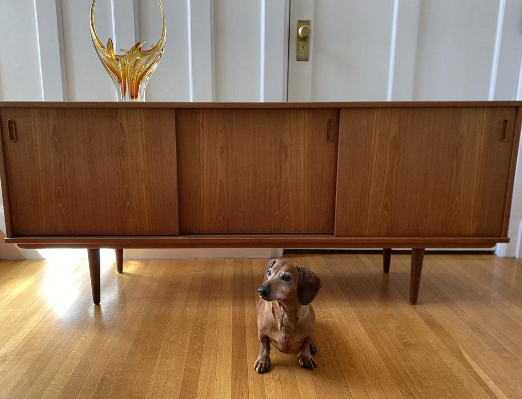 Front view of 1960s teak credenza with 3 sliding doors closed- Cook Street Vintage