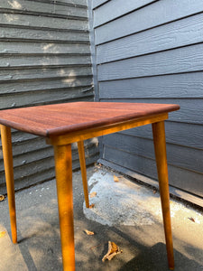 Side view of Gorgeous mid-century Scandinavian design teak side table with curved edge and elegant tapered legs- Cook Street Vintage
