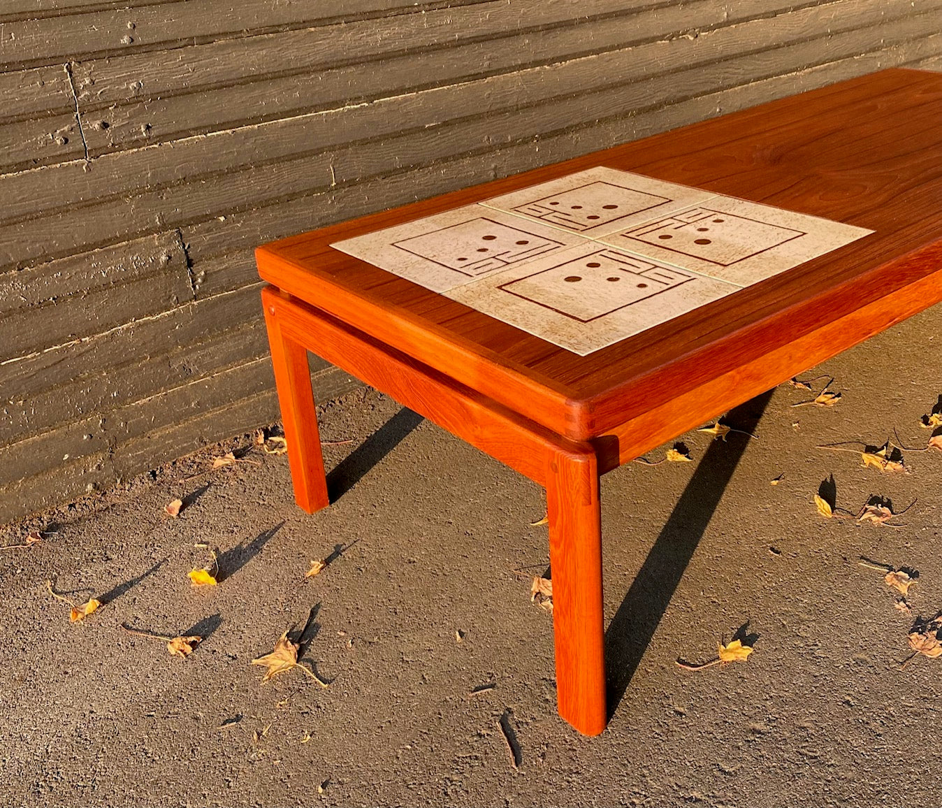 Stunning Danish mid-century modern teak coffee table with beautiful dovetail details and cream ceramic tile inlays. Attributed to H.W Klein- Cook Street Vintage