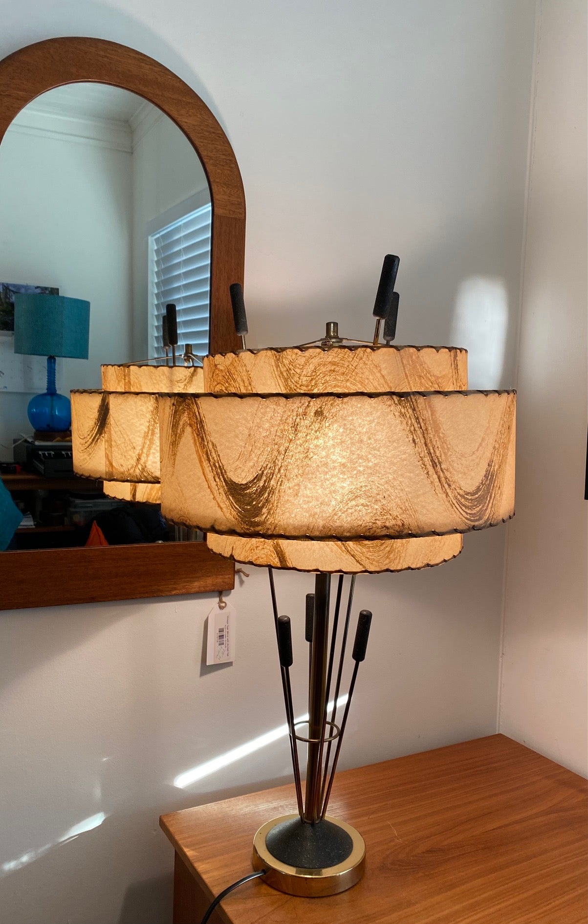 Retro table lamp with brass bull rush reed design. Brass base and original two tiered translucent shade with whip stitch details- Cook Street Vintage