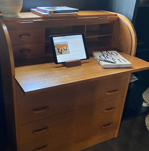Gorgeous Scandinavian design mid-century roll-top teak desk. Top rolls up to reveal cubby holes, two small drawers and a removable shelf. Top is a retractable desktop. Lower cabinet includes four large drawers- Cook Street Vintage