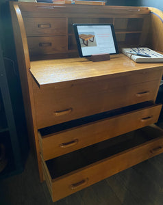 Gorgeous Scandinavian design mid-century roll-top teak desk. Top rolls up to reveal cubby holes, two small drawers and a removable shelf. Top is a retractable desktop. Lower cabinet includes four large drawers- Cook Street Vintage
