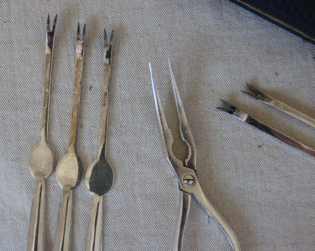 Close up of sterling silver shellfish forks and cracker- Cook Street Vintage
