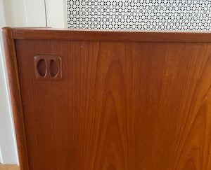 detail of door slide of Gorgeous Scandinavian design teak credenza. Four drawers with square insert pulls and two sliding cabinets with shelves- Cook Street Vintage