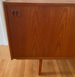 Gorgeous Scandinavian design teak credenza. Four drawers with square insert pulls and two sliding cabinets with shelves- Cook Street Vintage
