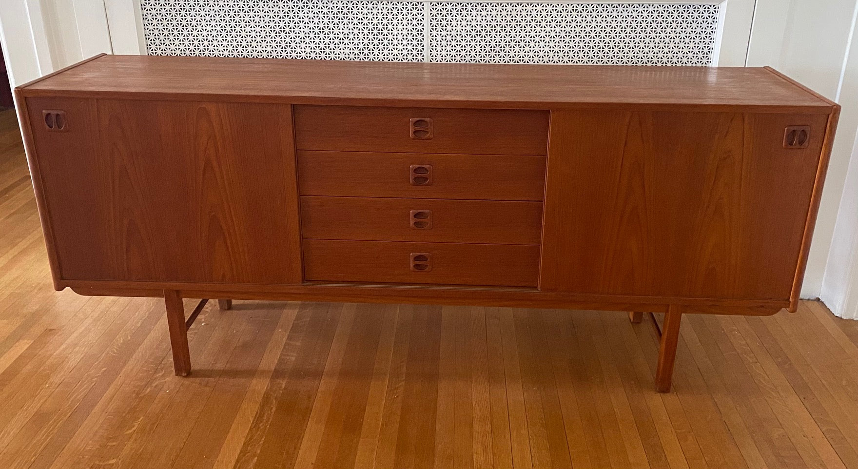 Gorgeous Scandinavian design teak credenza. Four drawers with square insert pulls and two sliding cabinets with shelves- Cook Street Vintage