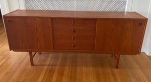 Gorgeous Scandinavian design teak credenza. Four drawers with square insert pulls and two sliding cabinets with shelves- Cook Street Vintage