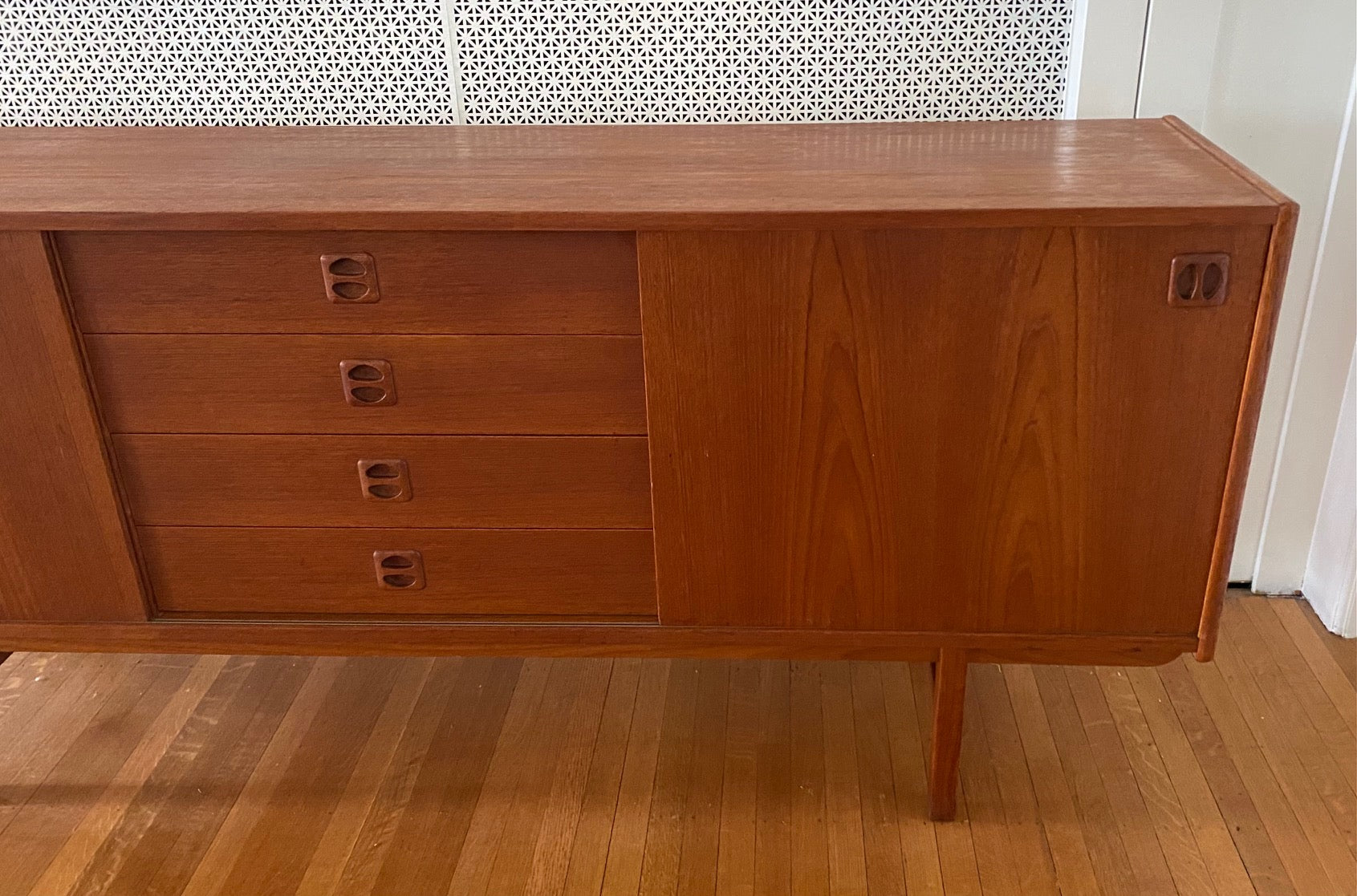 Gorgeous Scandinavian design teak credenza. Four drawers with square insert pulls and two sliding cabinets with shelves- Cook Street Vintage