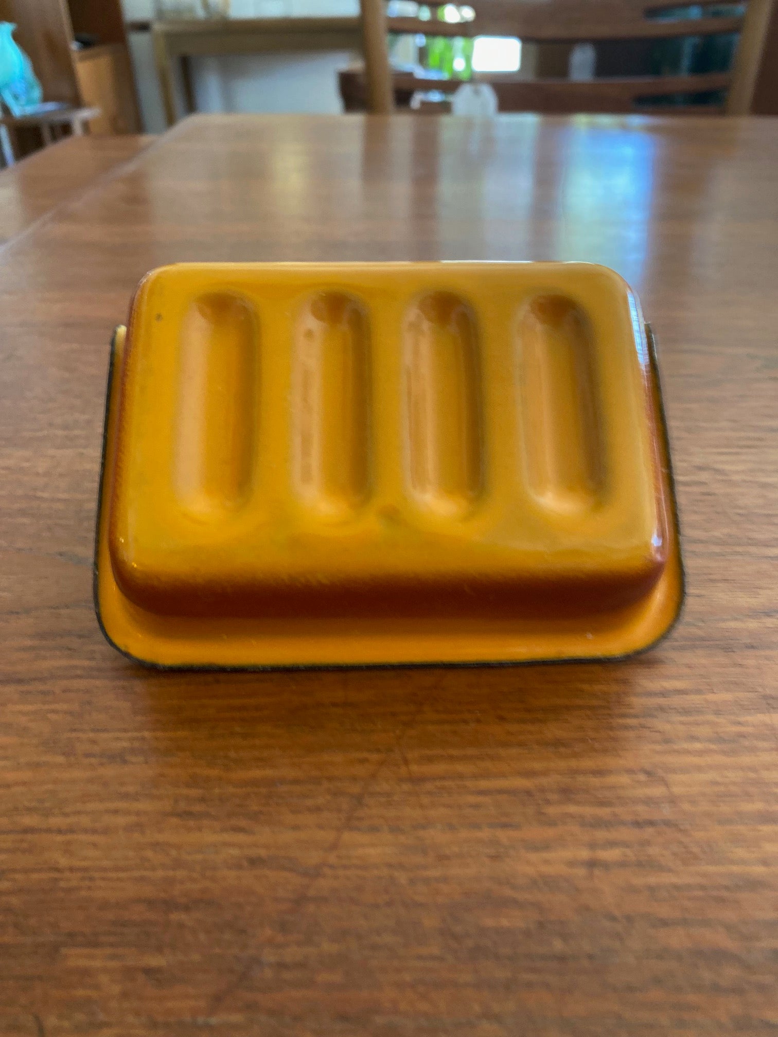 Bottom of vintage orange and grey metal soap dish - Cook Street Vintage