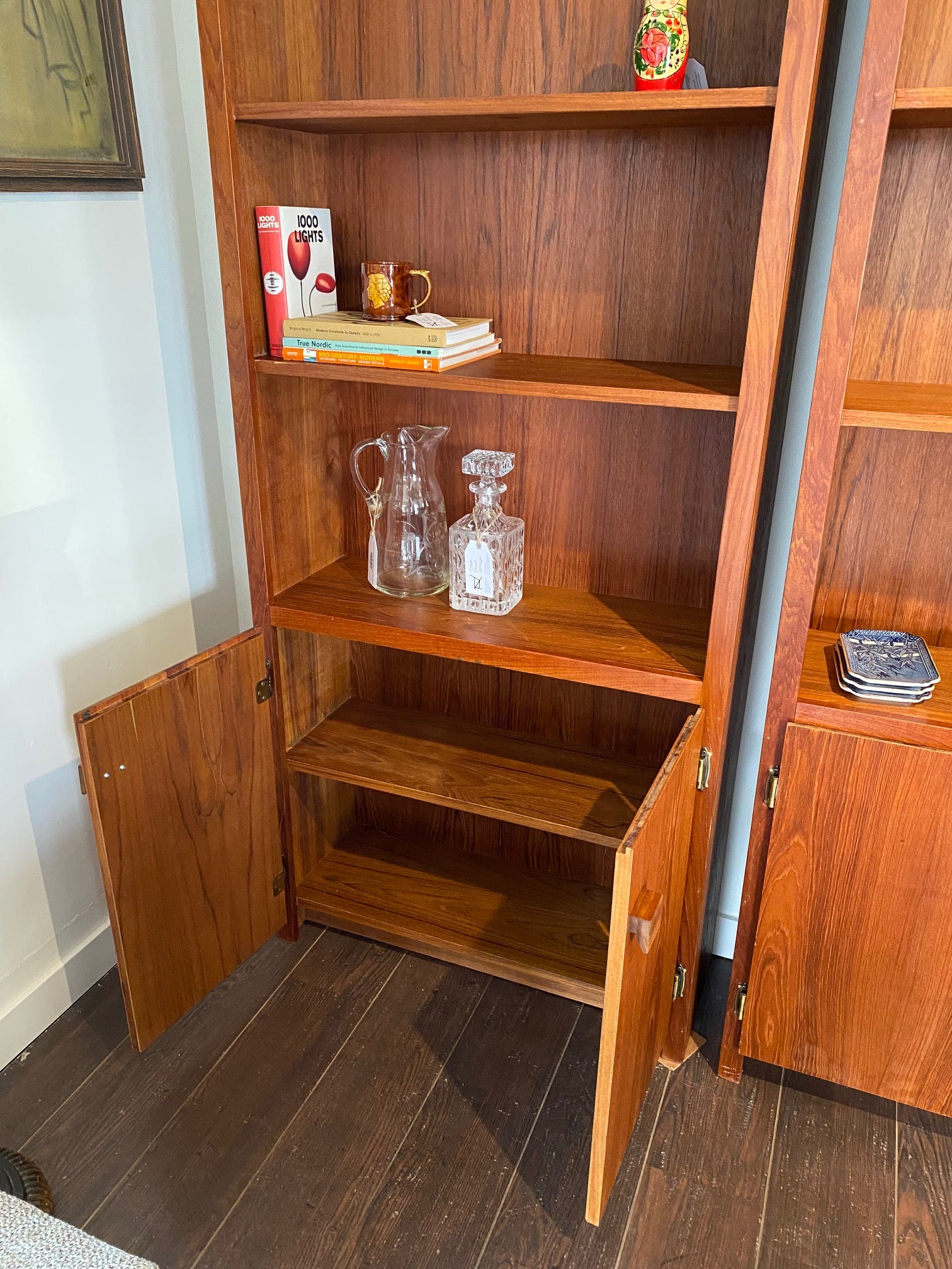 Bottom cabinet with open doors showing shelf of vintage teak shelf- Cook Street Vintage
