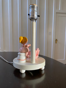 Back view of white nursery lamp with figure of mother reading to baby in pink cradle- Cook Street Vintage