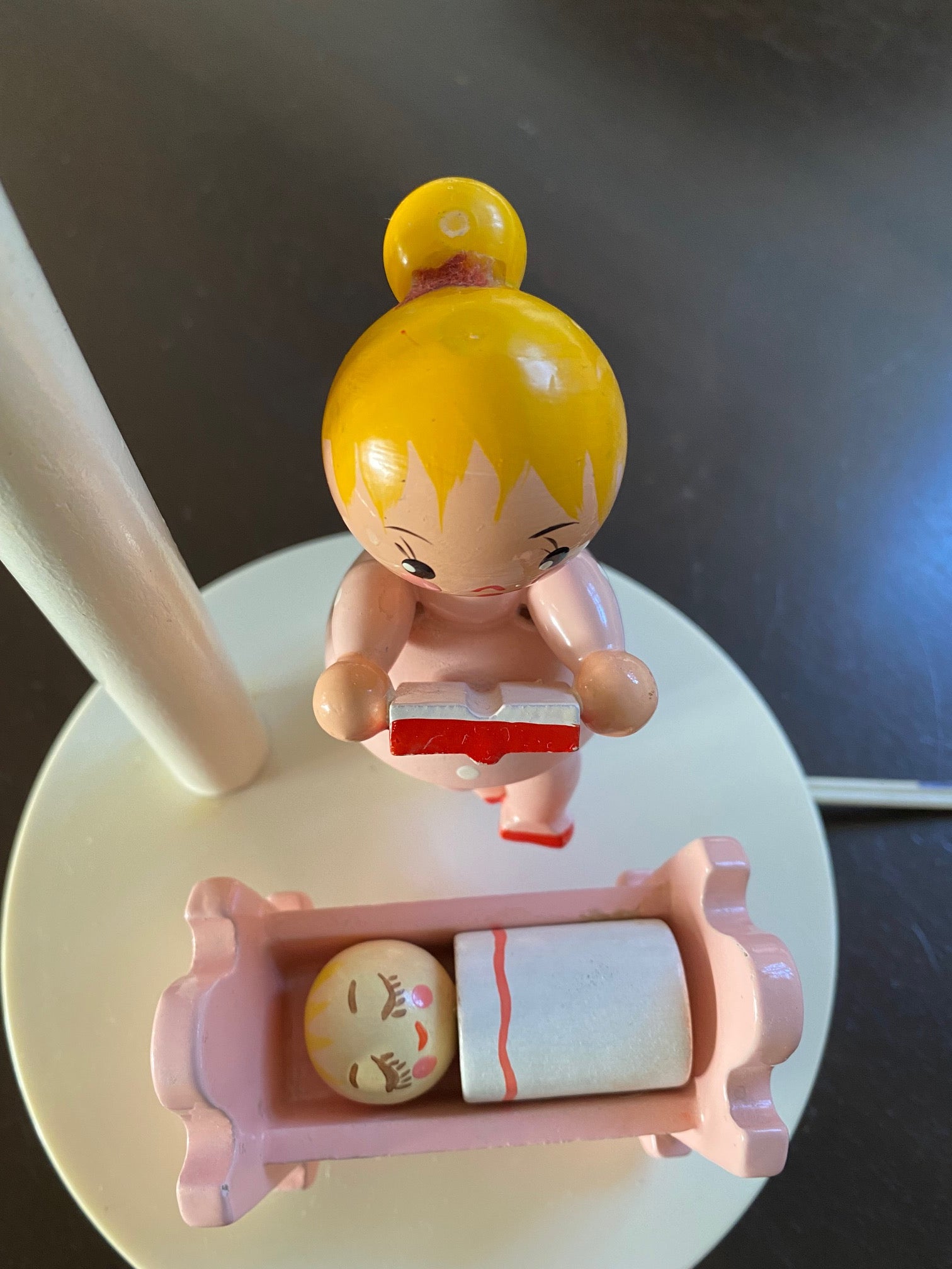 Birds eye view of baby in pink crib with mother reading story Irmi nursery lamp- Cook Street Vintage