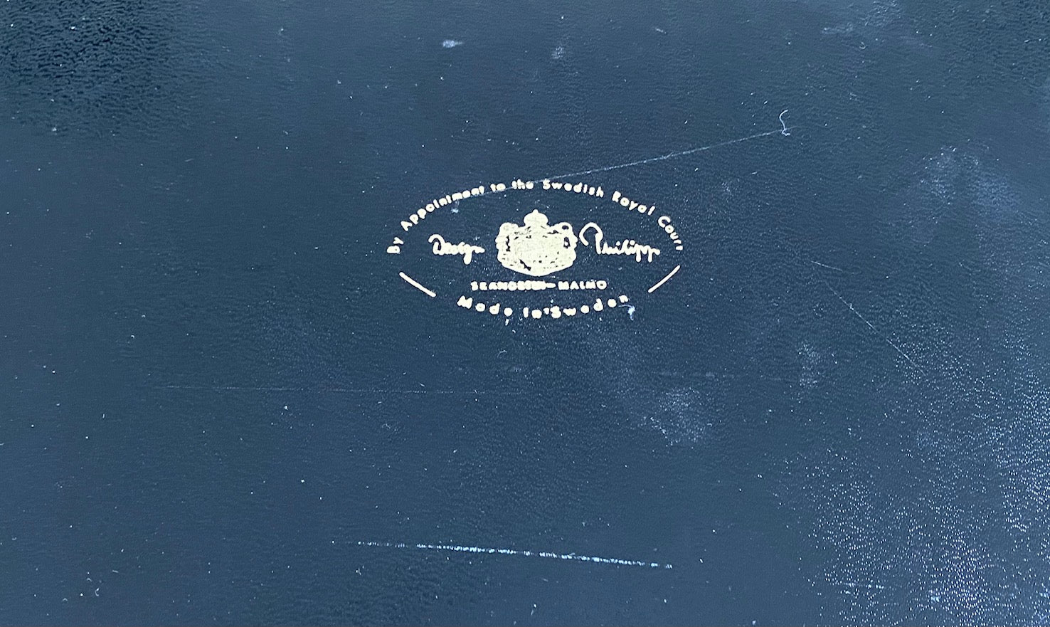 logo for Design Phillipp tray of 6 crystal whisky 4 ounce cocktail glasses designed by Appointment to the Royal Swedish Court. Rounded bottom so nice to hold and sip from. Lovely leatherette handled tray lined in Swedish red and gold- Cook Street Vintage