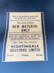 Label on bottom of Nightingale teak arm chair- Cook Street Vintage