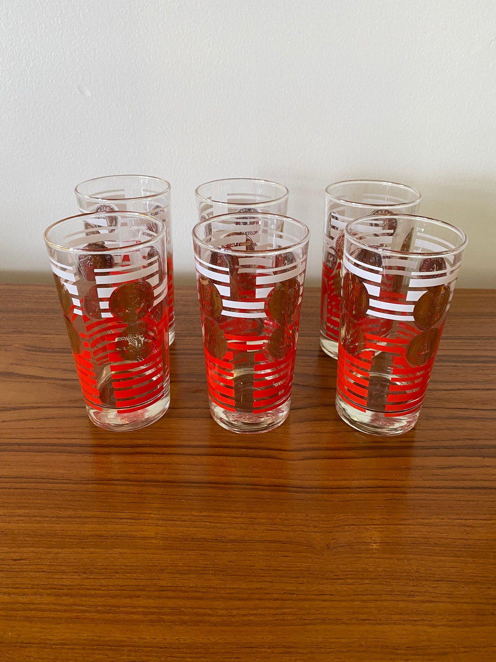Set of 6 Dorothy Thorpe highball glasses with red stripes on bottom, white stripes and gold medallions on top half- Cook Street Vintage