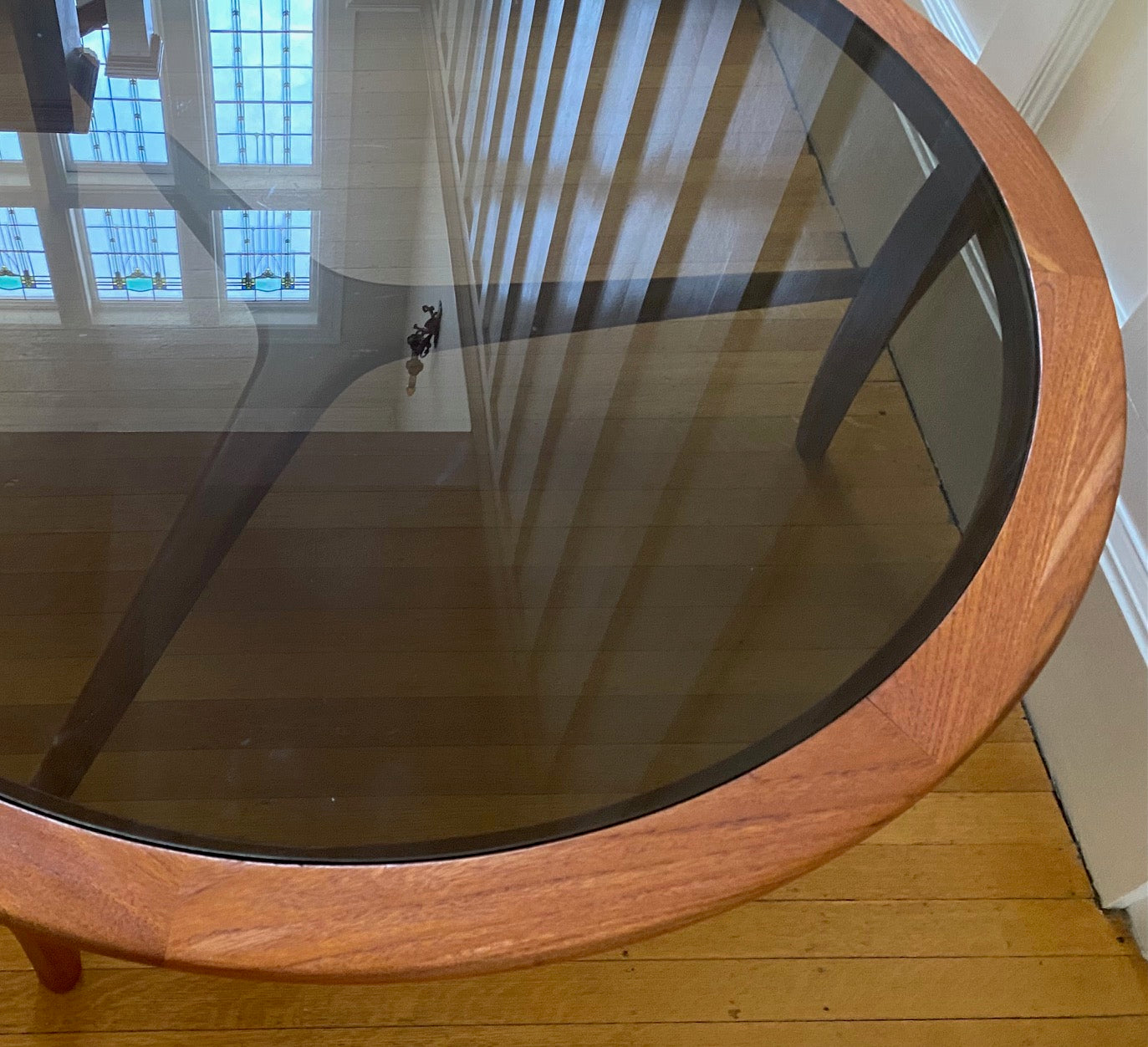 Detail of teak edge on Gorgeous Mid-century Scandinavian design round coffee table. Teak with smoke glass insert- Cook Street Vintage
