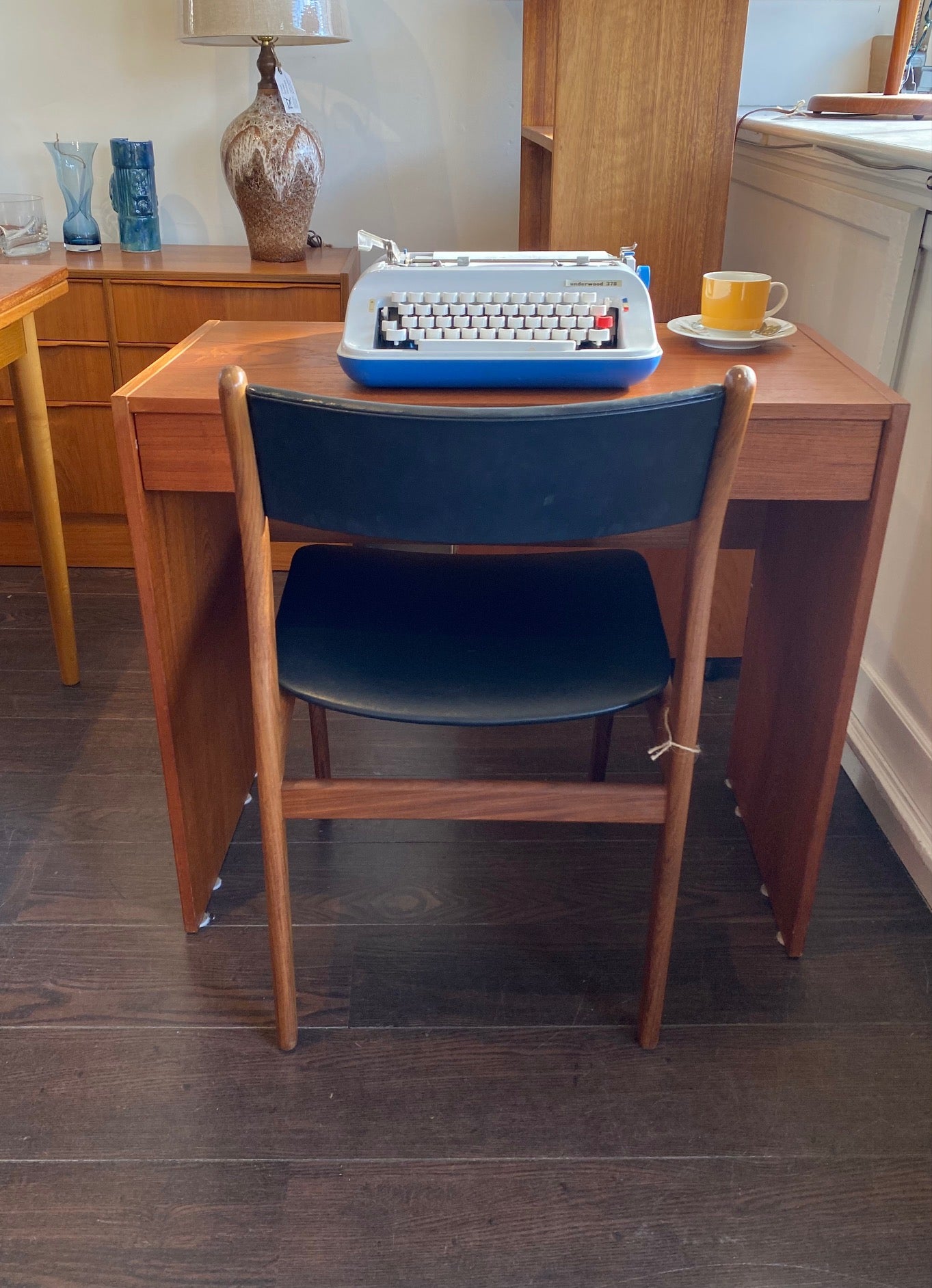 Sweet small teak desk with handy drawer. Would also make a handy entry table. Shown here with our portable Underwood typewriter- Cook Street Vintage