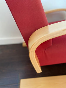 Detail of fabulous Artek Tank chair in red upholstery. Designed by Finnish designer Alvar Aalto in 1936- Cook Street Vintage