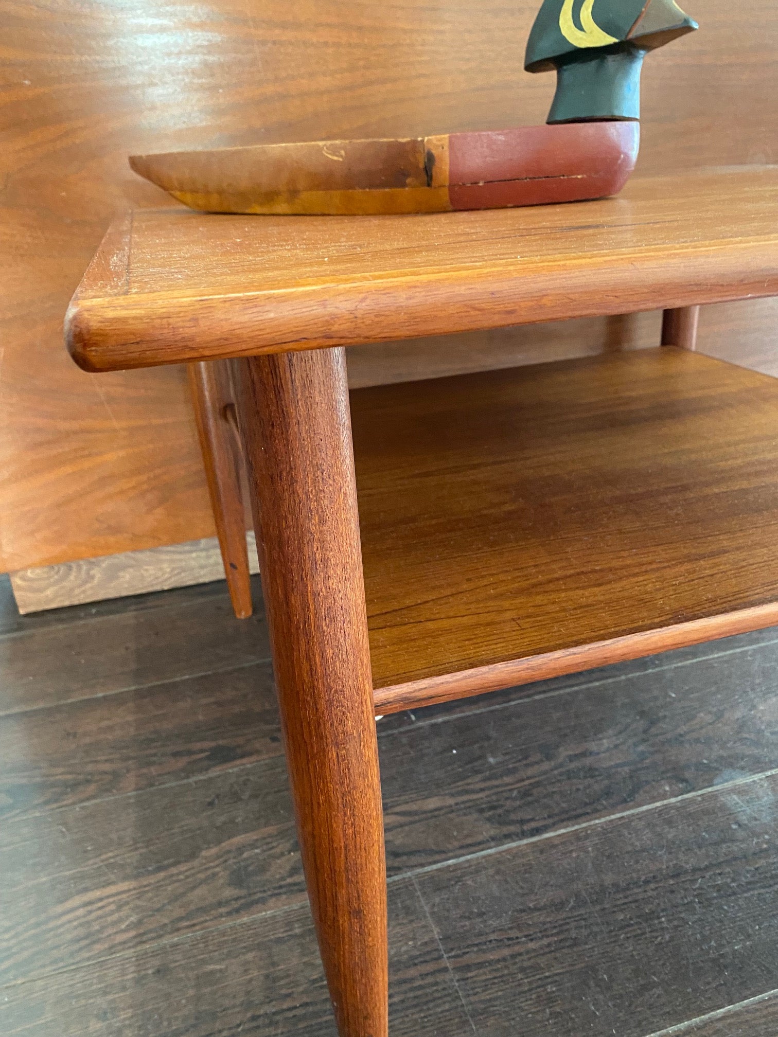 candlestick legs on two tiered vintage teak coffee table- Cook Street Vintage