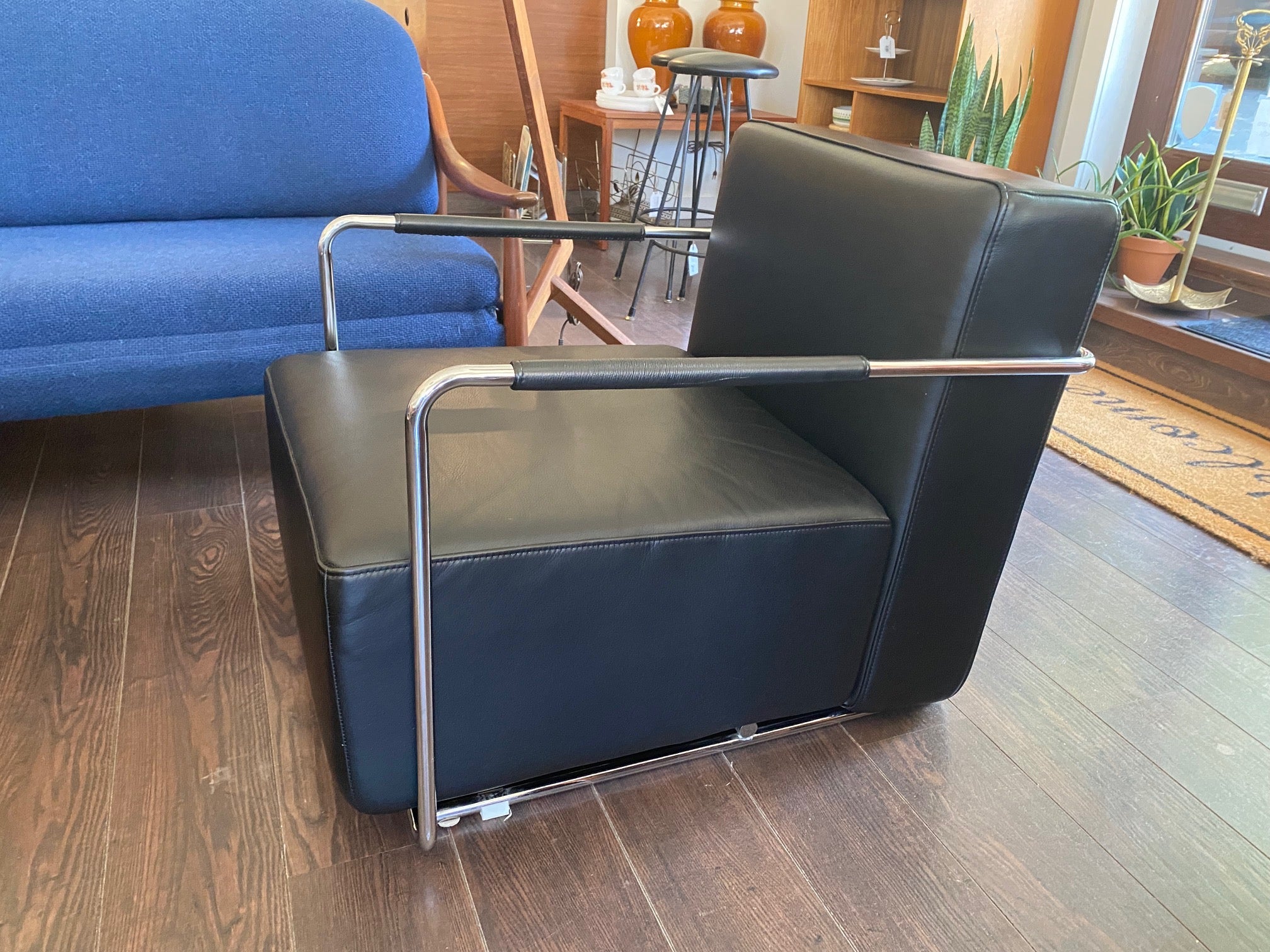 Gorgeous Italian leather reclining chair in the style of Antonio Citerrio. Dark black leather with tubular chrome frame makes this modern chair a must have for any room in your home of office- Cook Street Vintage