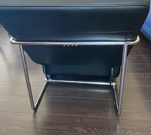 Back view of gorgeous Italian leather reclining chair in the style of Antonio Citerrio. Dark black leather with tubular chrome frame makes this modern chair a must have for any room in your home of office- Cook Street Vintage